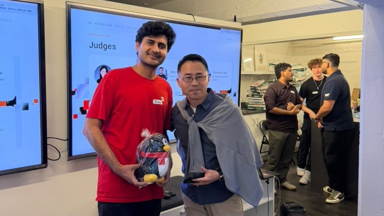 Zubair Zafar receiving the first place prize at The Executable World hackathon